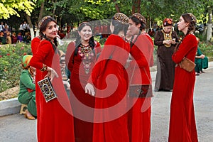 Ashgabat, Turkmenistan - May 25, 2017: Group of smiling female students in red national dresses with embroidery. Ashgabat, Turkme