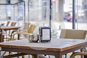 Ashtray and napkin on a terrace of a cafeteria photo