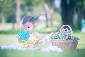 Asia Baby boy on green grass in the park