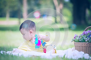 Asia Baby boy on green grass in the park