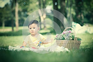 Asia Baby boy on green grass in the park