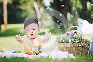 Asia Baby boy on green grass in the park