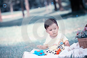 Asia Baby boy on green grass in the park