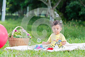 Asia Baby boy on green grass in the park