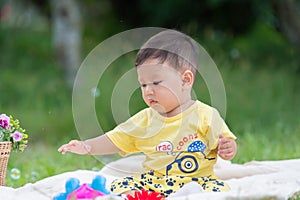 Asia Baby boy on green grass in the park