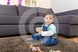 Asia baby boy play wooden toy block