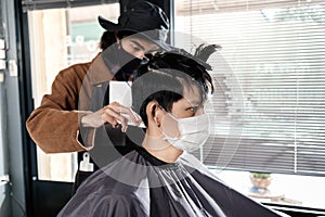 Asia Barber Shop Hair cut queueing customer`s wearing face mask prevention business reopening