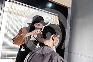 Asia Barber Shop Hair cut queueing customer`s wearing face mask prevention business reopening