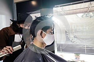 Asia Barber Shop Hair cut queueing customer`s wearing face mask prevention business reopening