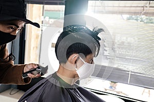 Asia Barber Shop Hair cut queueing customer`s wearing face mask prevention business reopening