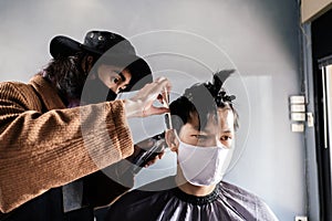 Asia Barber Shop Hair cut queueing customer`s wearing face mask prevention business reopening