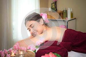 Asia beauty woman lying down on massage bed with scrub sugar and salt aroma at Thai spa and wellness center,