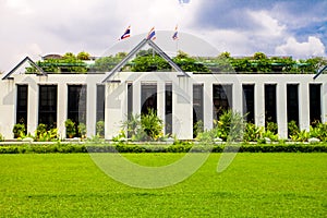 Asia botanic garden building exterior and green grass lawn with plant and flags on roof top