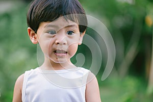 Asia boy he mouth aftertaste from eating chocolate ice cream  or chocolate dessert. A sweet-toothed child eat chocolate. Kid with