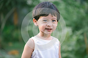 Asia boy he mouth aftertaste from eating chocolate ice cream  or chocolate dessert. A sweet-toothed child eat chocolate. Kid with