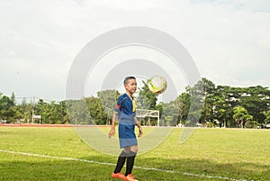 Asia boy playing Soccer football field stadium grass line ball b