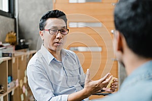 Asia businesspeople chatting to intern discussing job interview colleagues having conversation and communication meeting