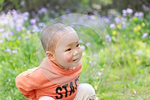 Asia Chinese little baby toddler boy child play outdoor in park forest sunny happy smile carefree flower meadow spring summer