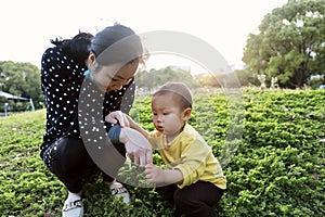 Asia Chinese little boy toddler child and mother Mom enjoy Spring have fun outside embrace nature outdoor carefree childhood love