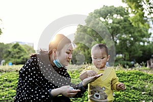 Asia Chinese little boy toddler child and mother Mom enjoy Spring have fun outside embrace nature outdoor carefree childhood play