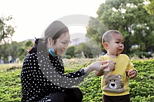 Asia Chinese little boy toddler child and mother Mom play games have fun outside embrace nature outdoor carefree childhood play