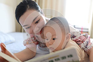 Asia Chinese Mom toddler baby boy son read book indoor home teaching early education lying on bed maternal love family