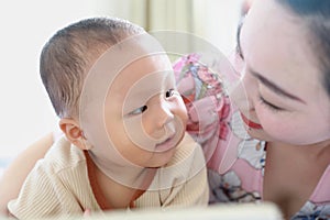 Asia Chinese Mom toddler baby boy son read book indoor home teaching early education lying on bed maternal love family