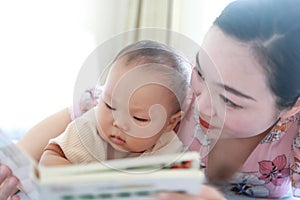 Asia Chinese Mom toddler baby boy son read book indoor home teaching early education lying on bed maternal love family