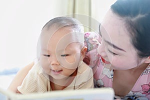 Asia Chinese Mom toddler baby boy son read book indoor home teaching early education lying on bed maternal love family