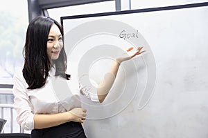 Asia Chinese office lady woman girl hand write success at whiteboard work smile wear business occupation suit workplace