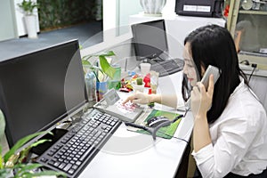 Asia Chinese office lady woman girl make a phone call at work smile laptop smart outfit wear business occupation suit workplace