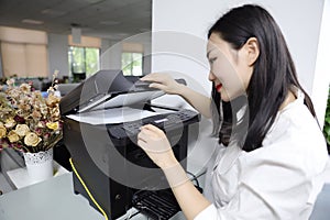 Asia Chinese office lady woman girl print copy paper use printer copier at work smile wear business occupation suit workplace