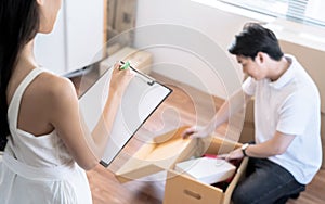 Asia couple keeps things in cardboard boxes to move to the new house.