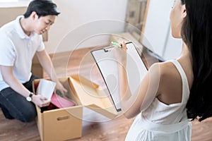 Asia couple keeps things in cardboard boxes to move to the new house.