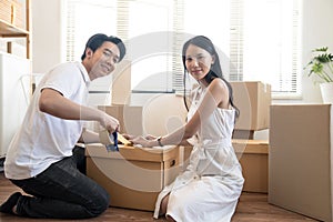 Asia couple keeps things in cardboard boxes to move to the new house.