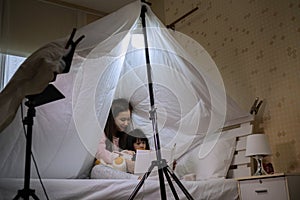 Asia family mother reading to children book in tent