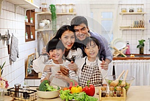 Asia family smile portrait and cooking food in kitchen room.