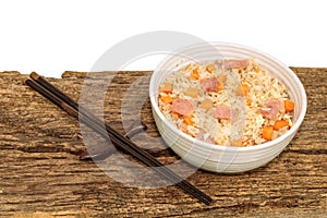 Asia food fried rice with egg ham carrot in bowl isolated on wood table.