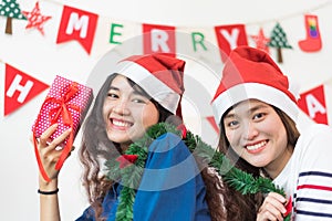 Asia girl friends wear santa hat in Christmas and new year party