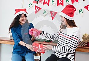 Asia girl friends wear santa hat in merry christmas party and ex