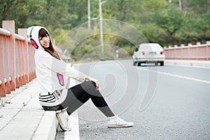 Asia girl sitting roadside