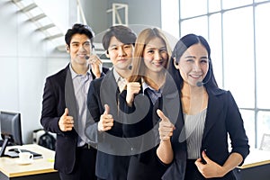 Asia Group of call center workers or Confident business team with headset in office