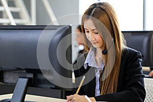 Asia Group of call center workers or Confident business team with headset in office