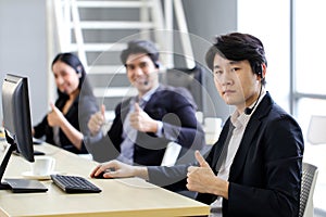 Asia Group of call center workers or Confident business team with headset in office