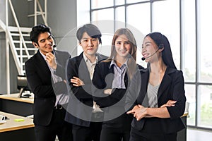 Asia Group of call center workers or Confident business team with headset in office