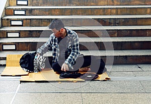 Asia homeless man sitting on walking street in the capital city.