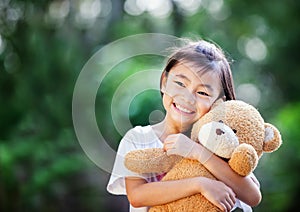 Asia little girl with doll bear