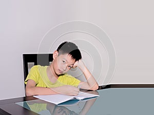 Asia little student boy studying and doing his homework at home
