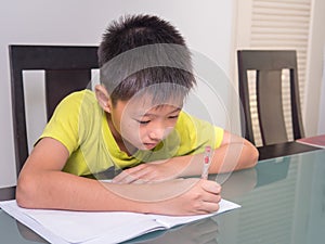 Asia little student boy studying and doing his homework