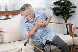 Asia man with chest pain suffering from heart attack in home, Illness of the elderly, Asian elderly.
